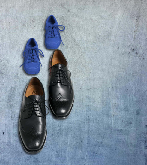 Business-Schuhe und Sportschuhe stehen hintereinander als Sinnbild für Wandel, Neuausrichtung und den mutigen Schritt in eine neue berufliche Zukunft.