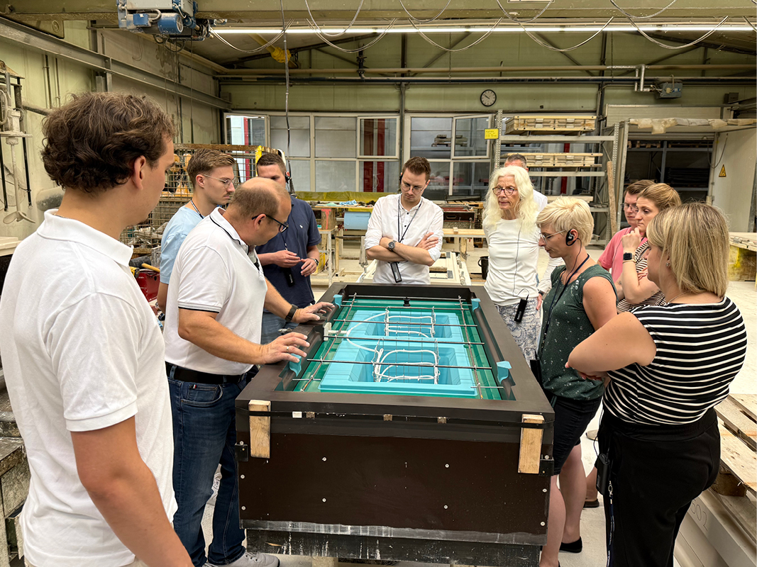 Besuchergruppe betrachtet die Fertigung von Keramikspülen, ein praxisnaher Einblick in Küchenplanung, Materialien, Küchenmöbel und moderne Designküchen.