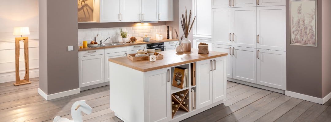 Helle moderne Küche mit weißen Fronten, Holzarbeitsplatte und Kücheninsel – klassisches Küchendesign und individuelle Küchenplanung bei Alliance Küchen.
